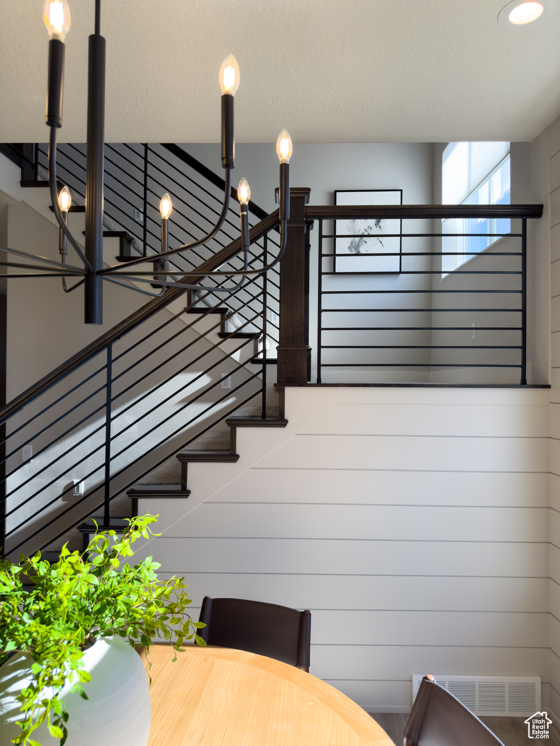 Stairway featuring a notable chandelier