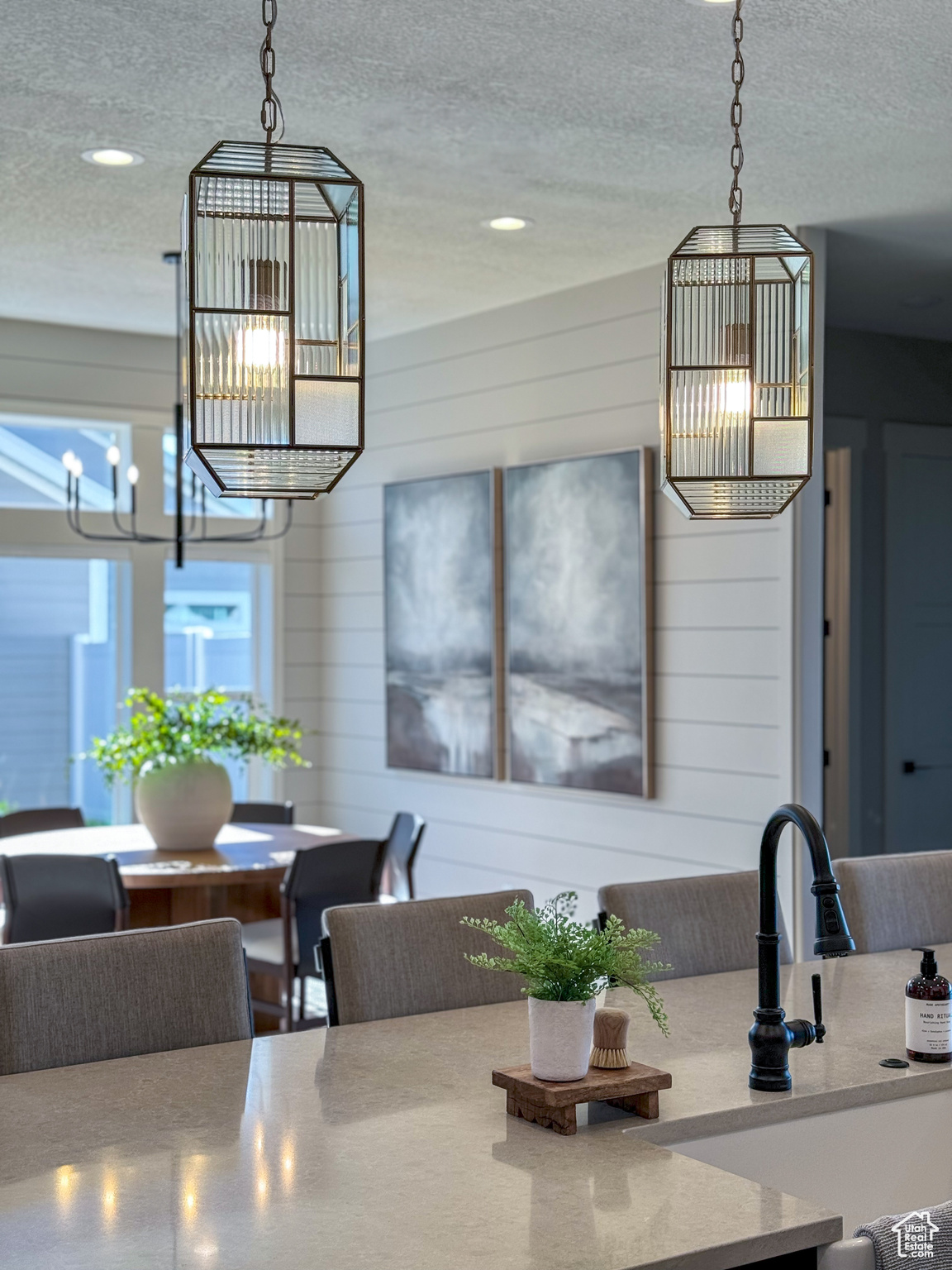 Kitchen featuring wood walls, a chandelier, and a textured ceiling