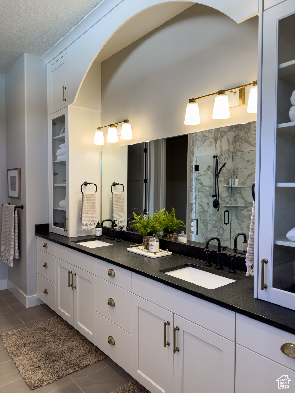 Bathroom featuring vanity, tile patterned floors, and an enclosed shower