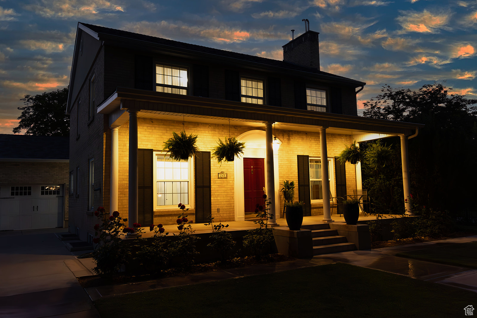 View of front of house featuring covered porch and a garage