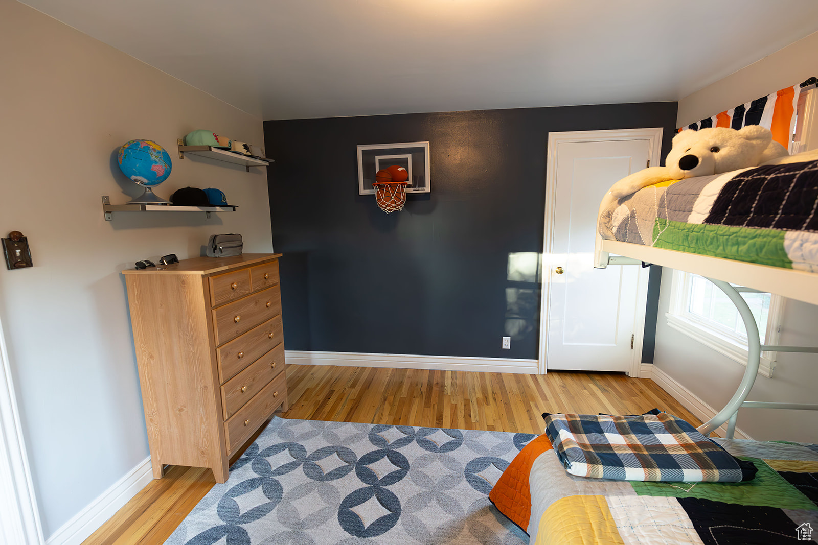 Bedroom with light hardwood / wood-style flooring