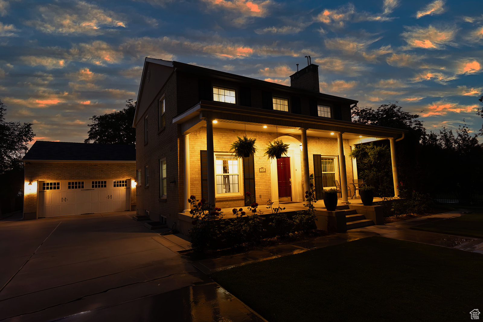 View of front facade with a porch, a garage, and an outdoor structure