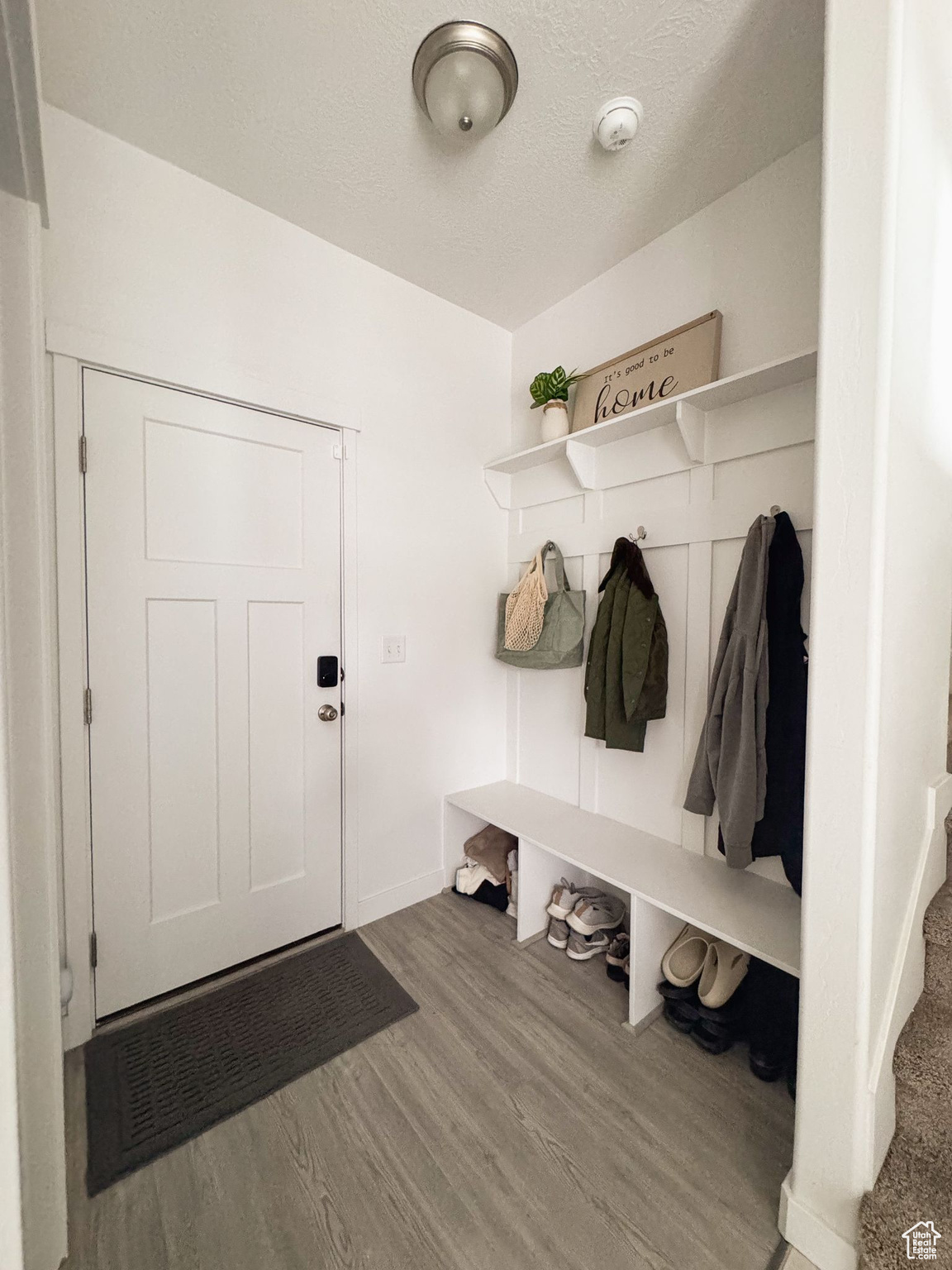 Mudroom with hardwood / wood-style floors and a textured ceiling