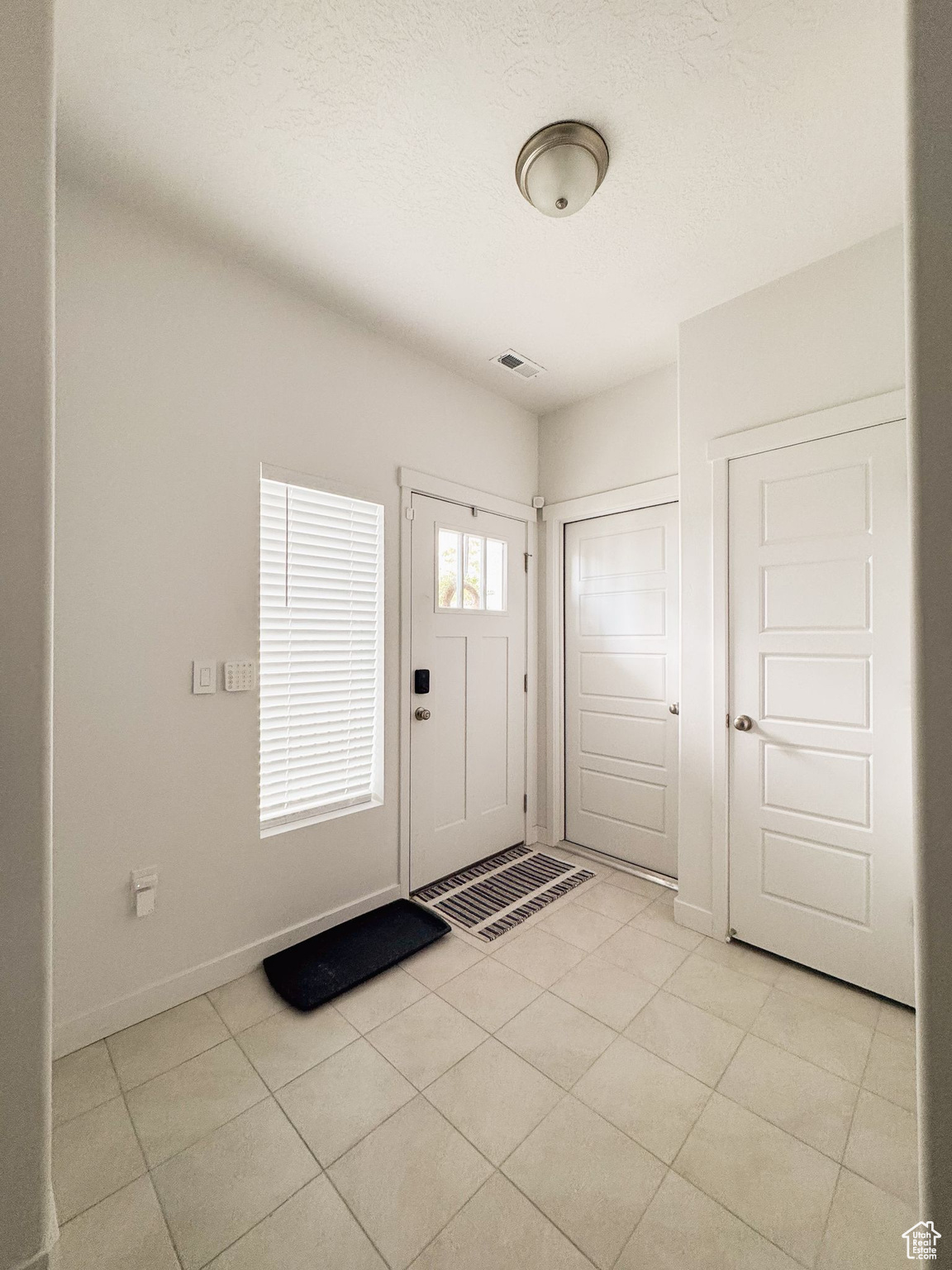 Entrance foyer featuring light tile patterned floors