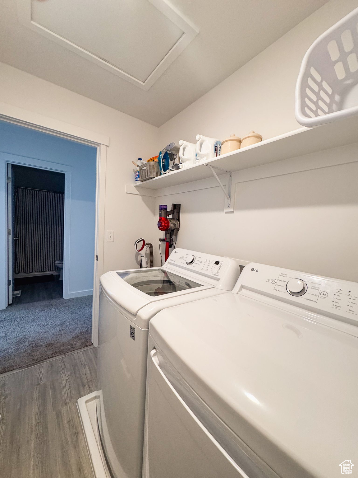 Washroom with separate washer and dryer and dark hardwood / wood-style flooring