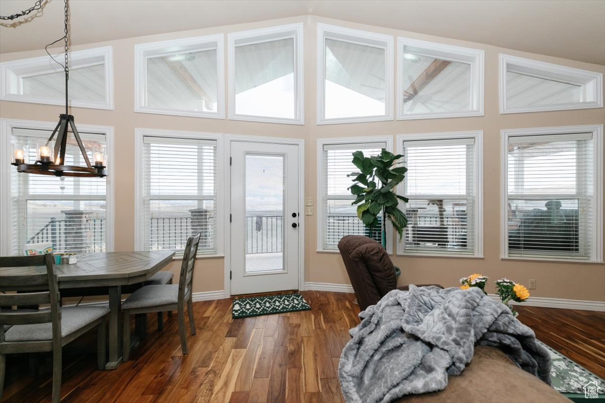 Entryway featuring a wealth of natural light, dark hardwood / wood-style flooring, and a notable chandelier