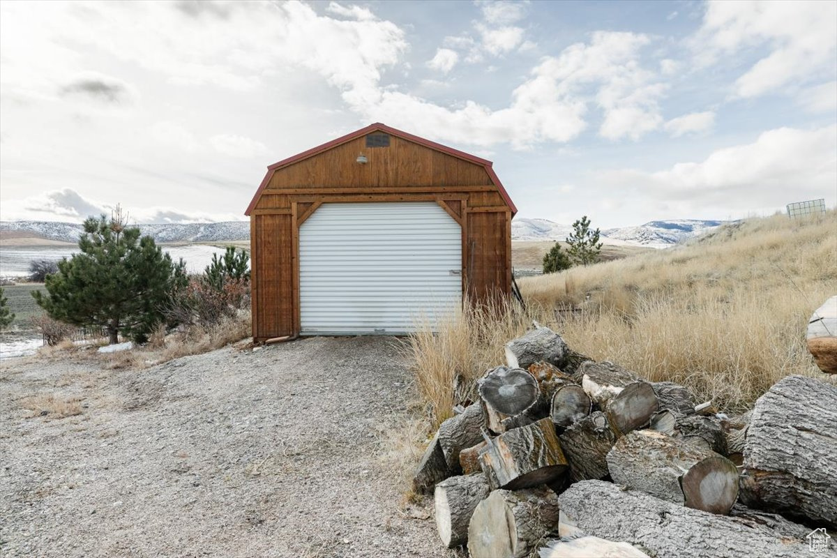 View of outbuilding with a garage and a water and mountain view