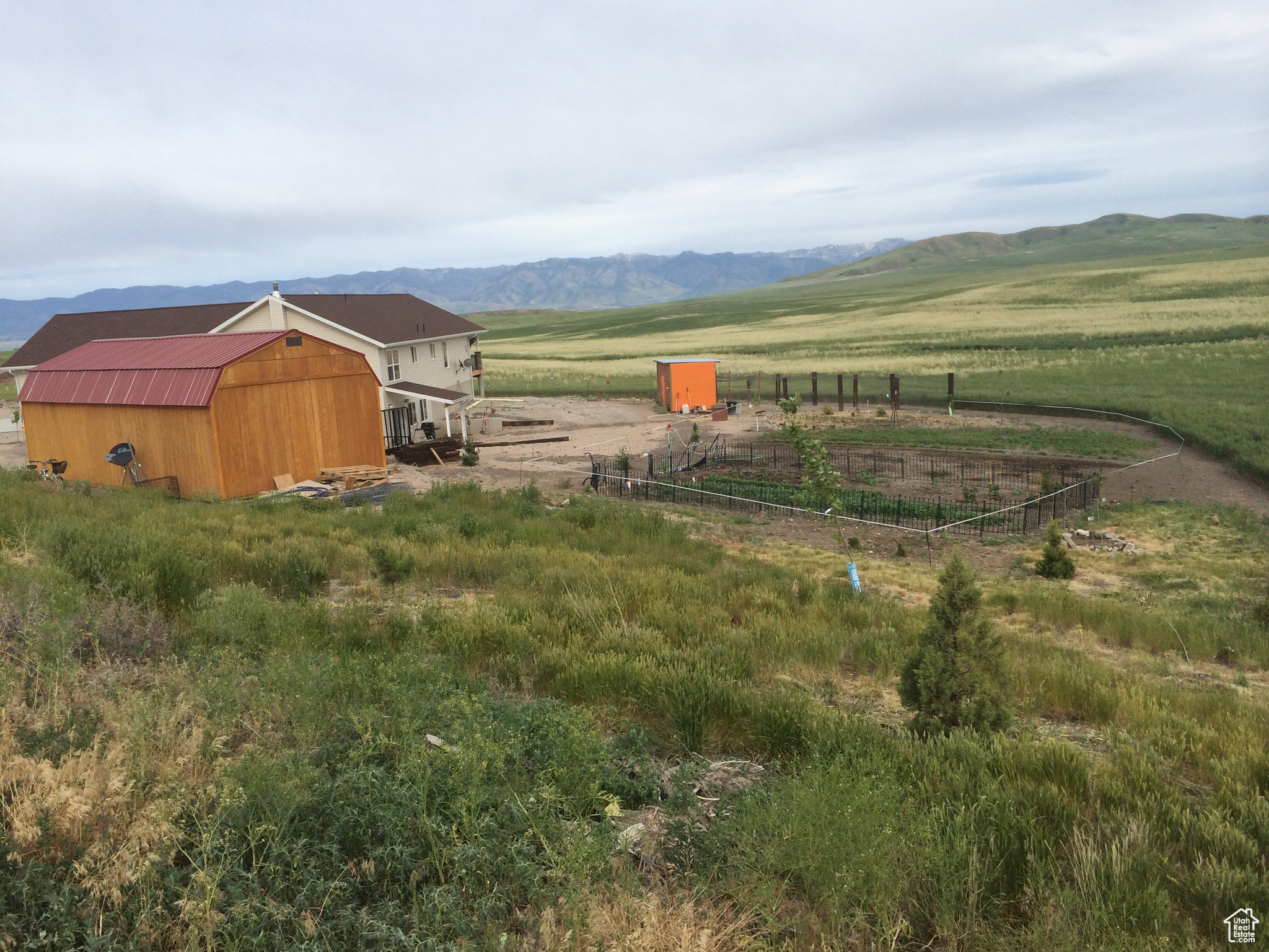 View of yard featuring a mountain view, an outbuilding, and a rural view