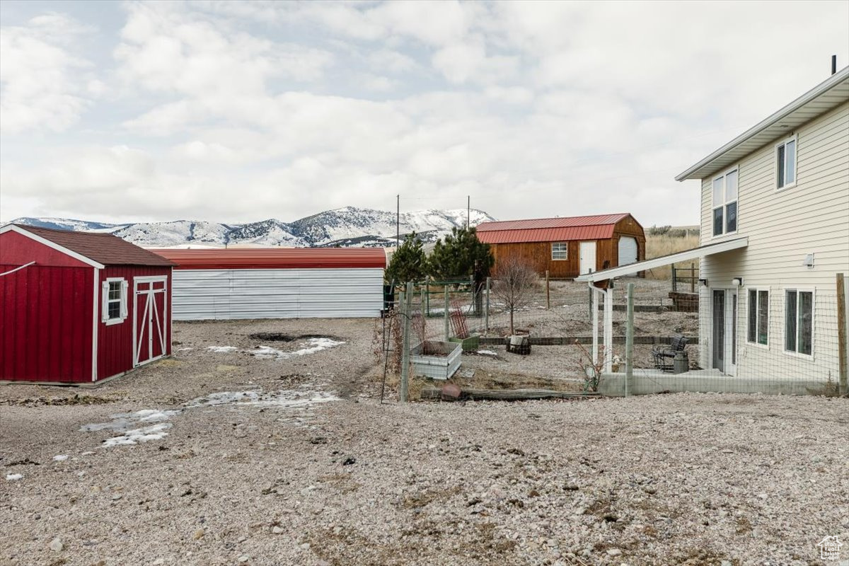 View of yard with a mountain view and a storage unit