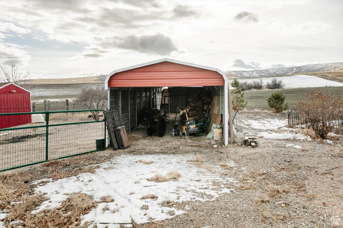 Snow covered structure with a mountain view