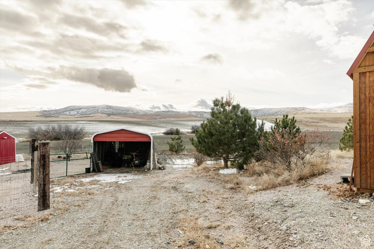 View of yard featuring a mountain view and an outdoor structure