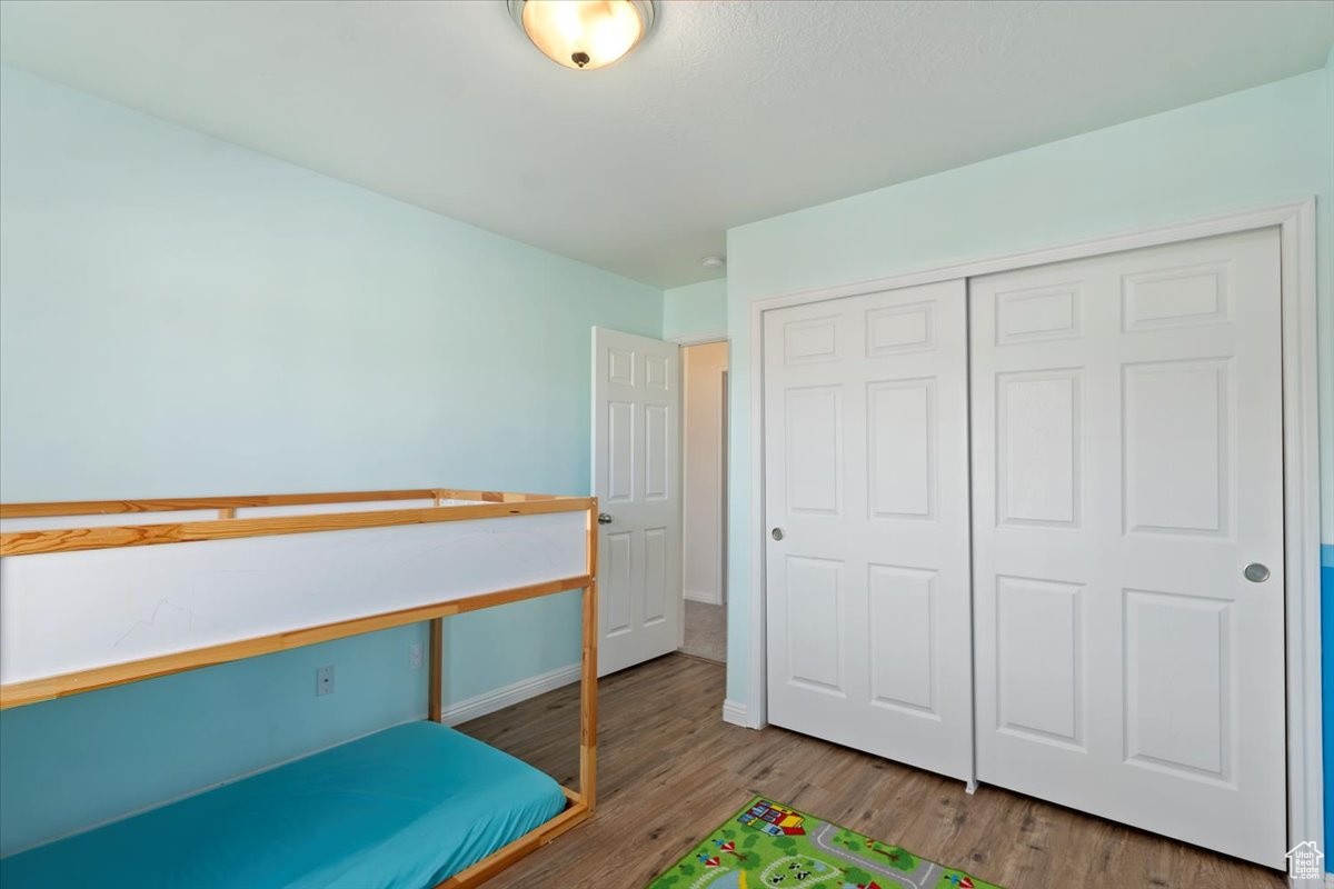 Bedroom featuring hardwood / wood-style floors and a closet