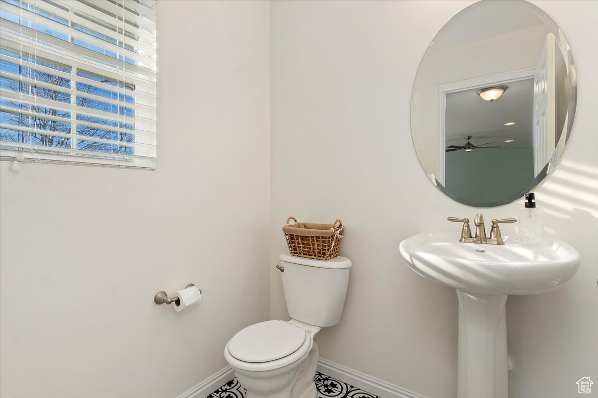 Bathroom featuring ceiling fan, toilet, and sink