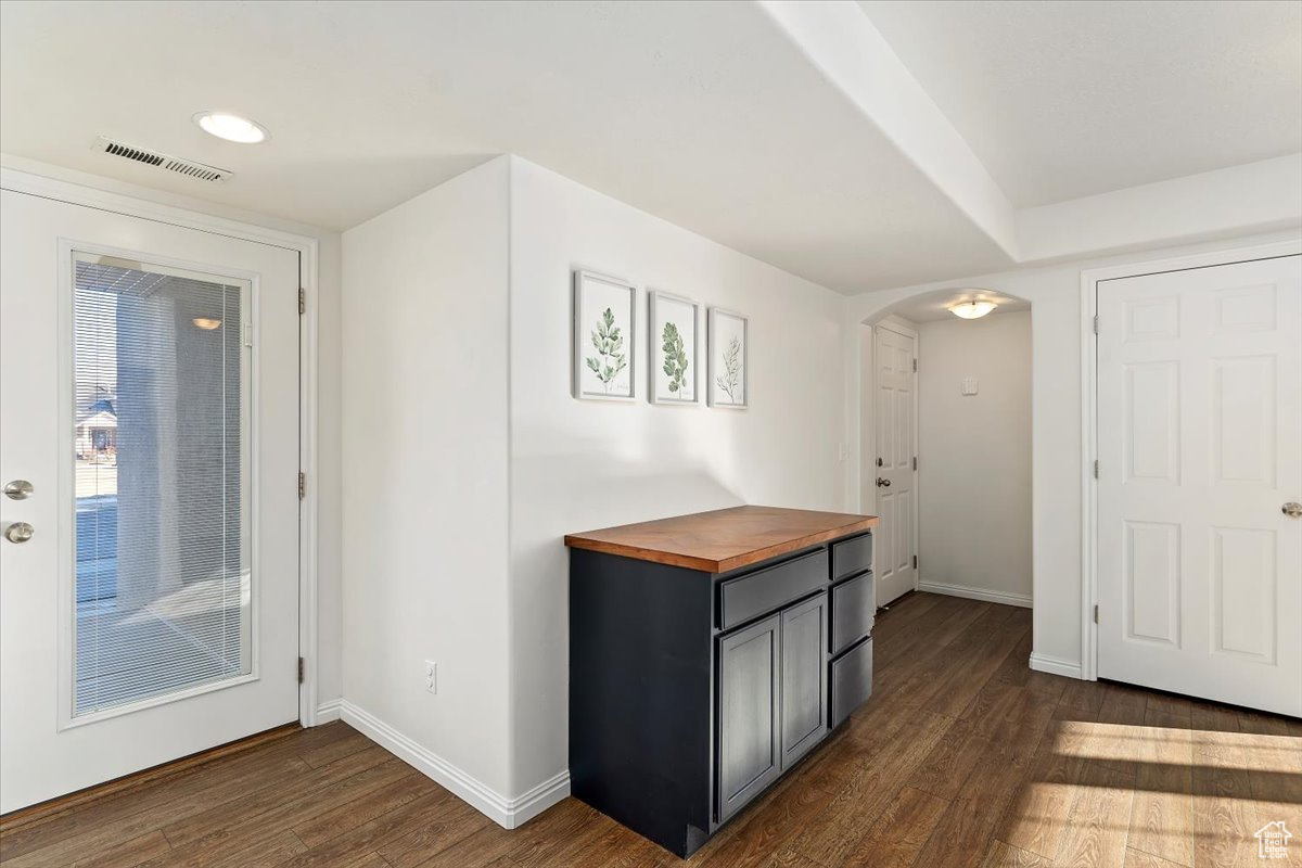 Corridor with dark hardwood / wood-style floors