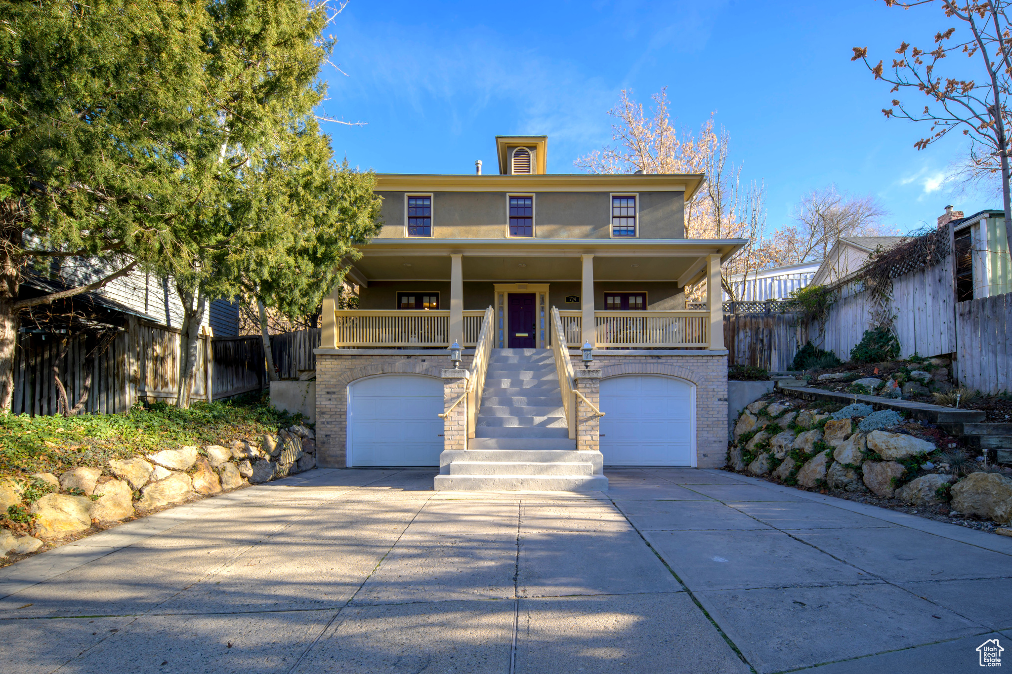 View of front facade featuring covered porch and a garage