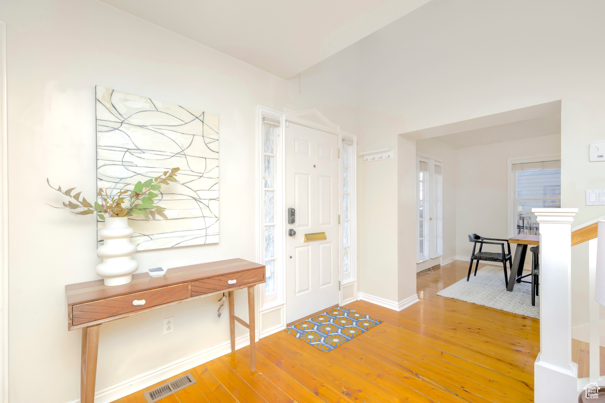 Entrance foyer with wood-type flooring