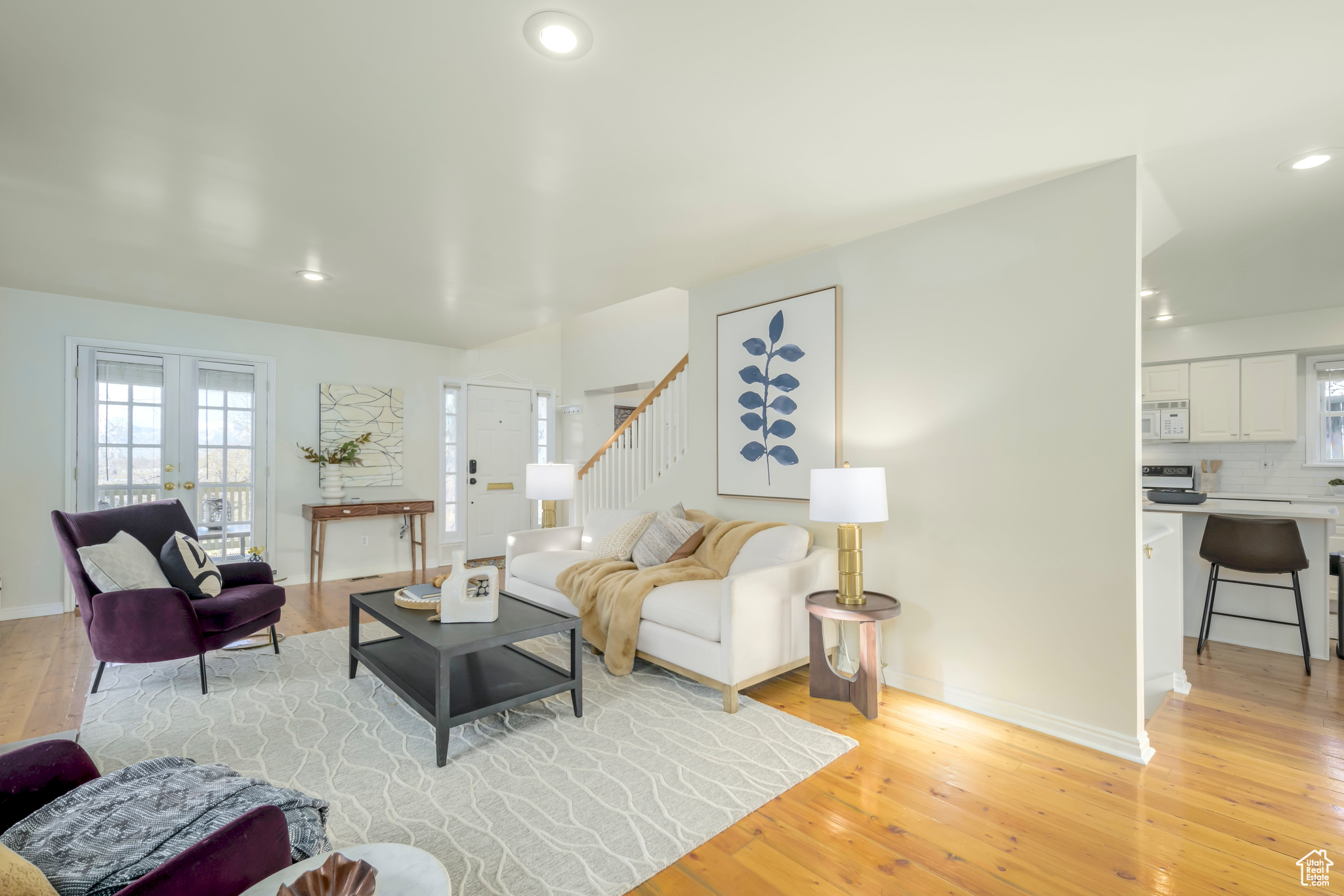 Living room with french doors and light wood-type flooring