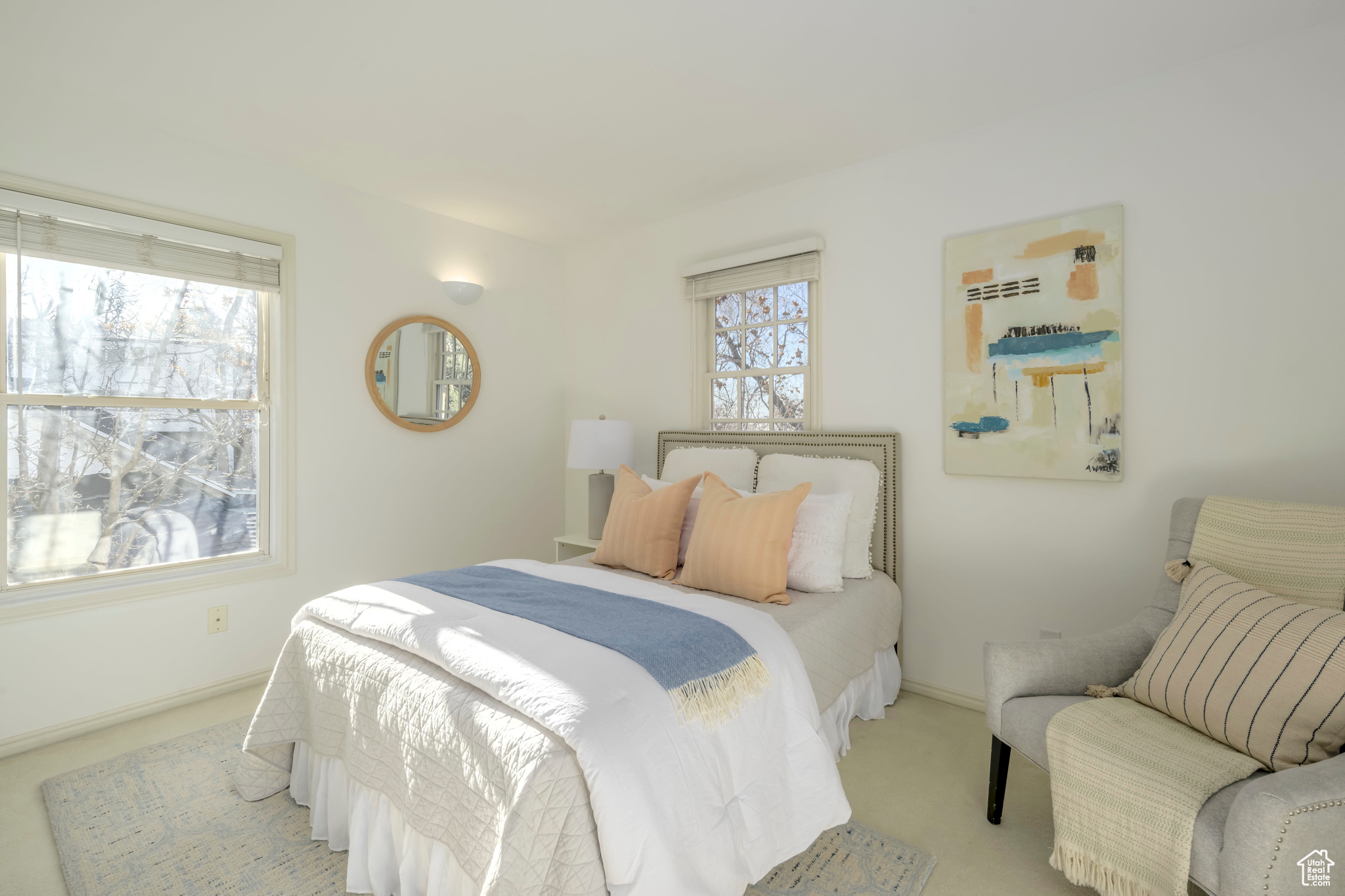 Carpeted bedroom featuring multiple windows