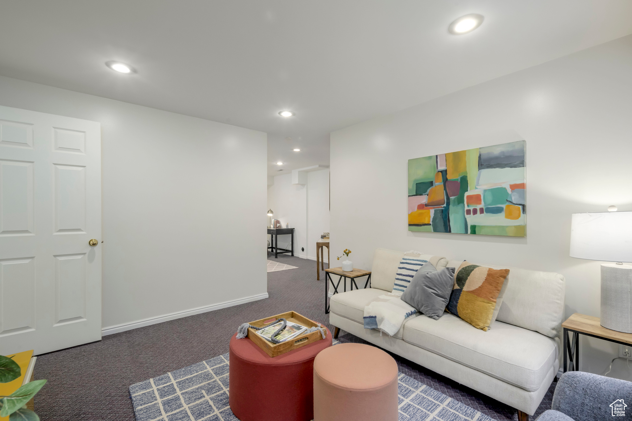 Living room featuring dark colored carpet