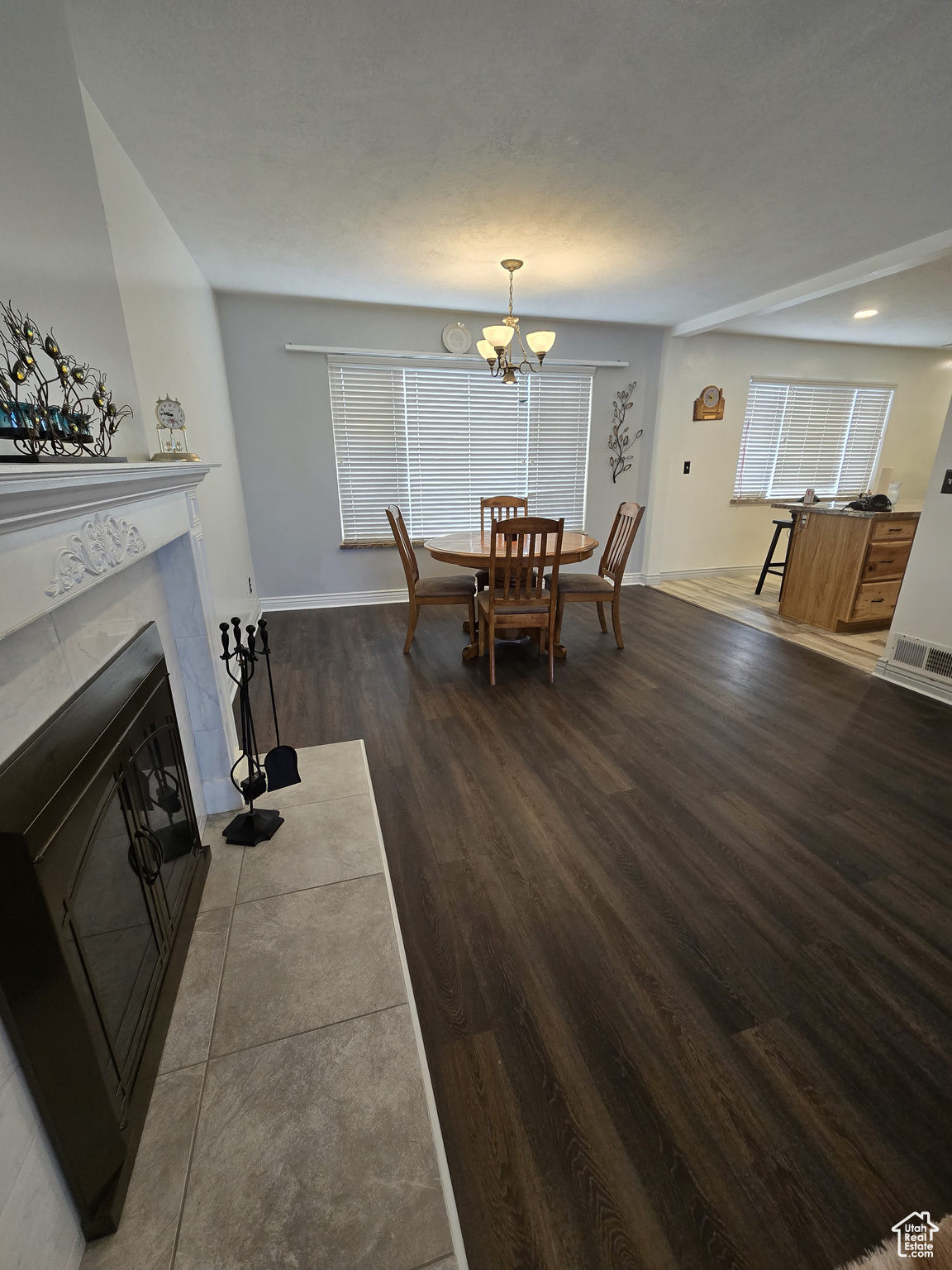 Dining space featuring a notable chandelier and dark hardwood / wood-style flooring