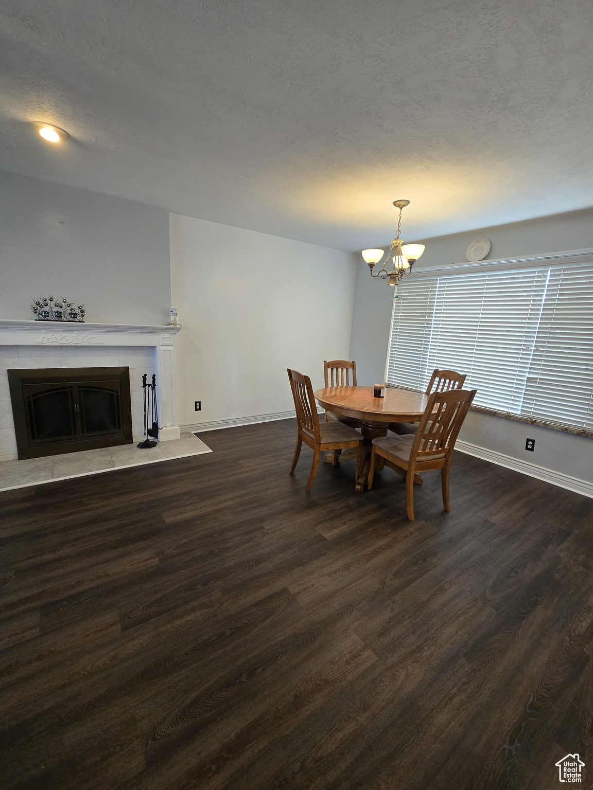 Dining space featuring dark hardwood / wood-style floors and an inviting chandelier