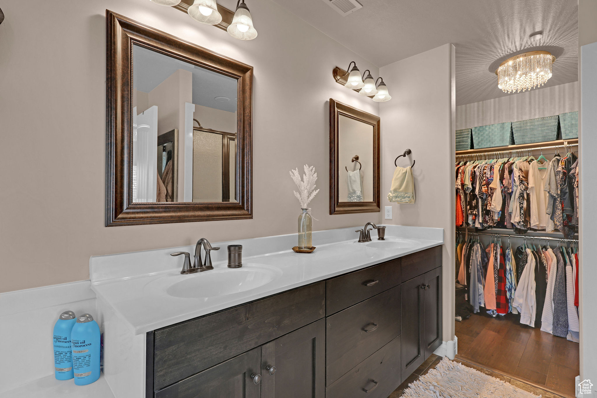 Bathroom with hardwood / wood-style flooring, vanity, and a notable chandelier