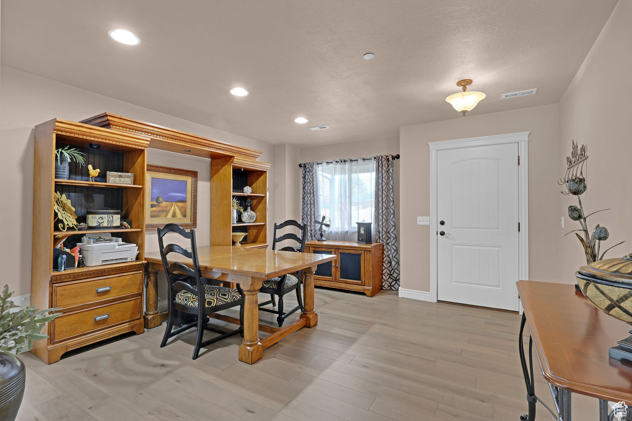 Dining space with light hardwood / wood-style floors