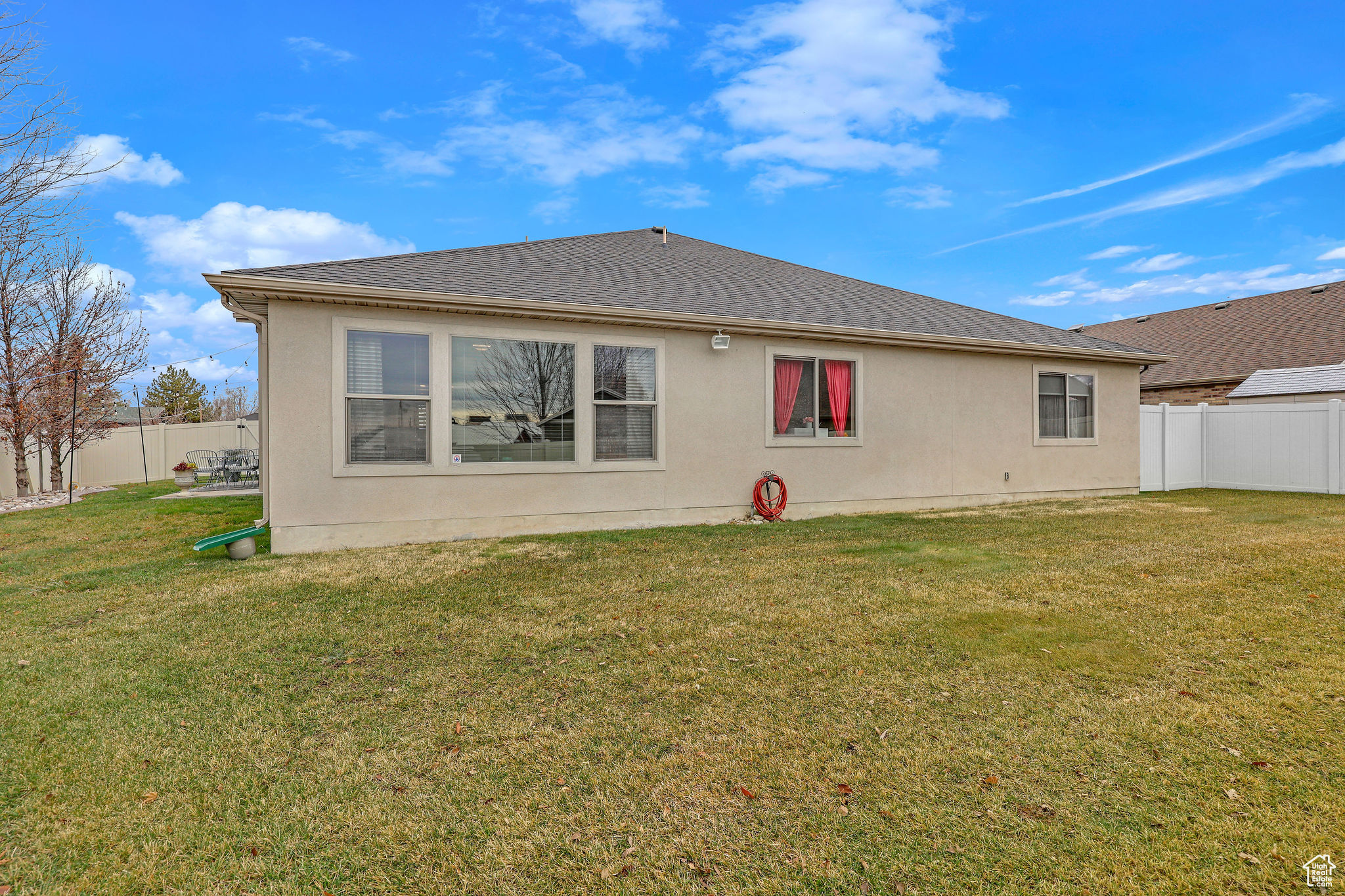 Rear view of property featuring a lawn