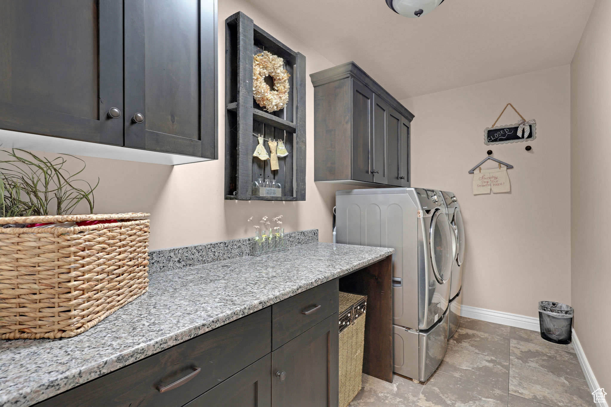 Washroom with cabinets and washer and clothes dryer