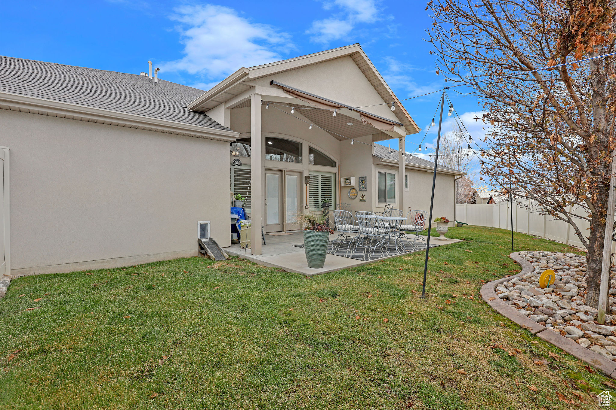 Rear view of house with a patio and a lawn