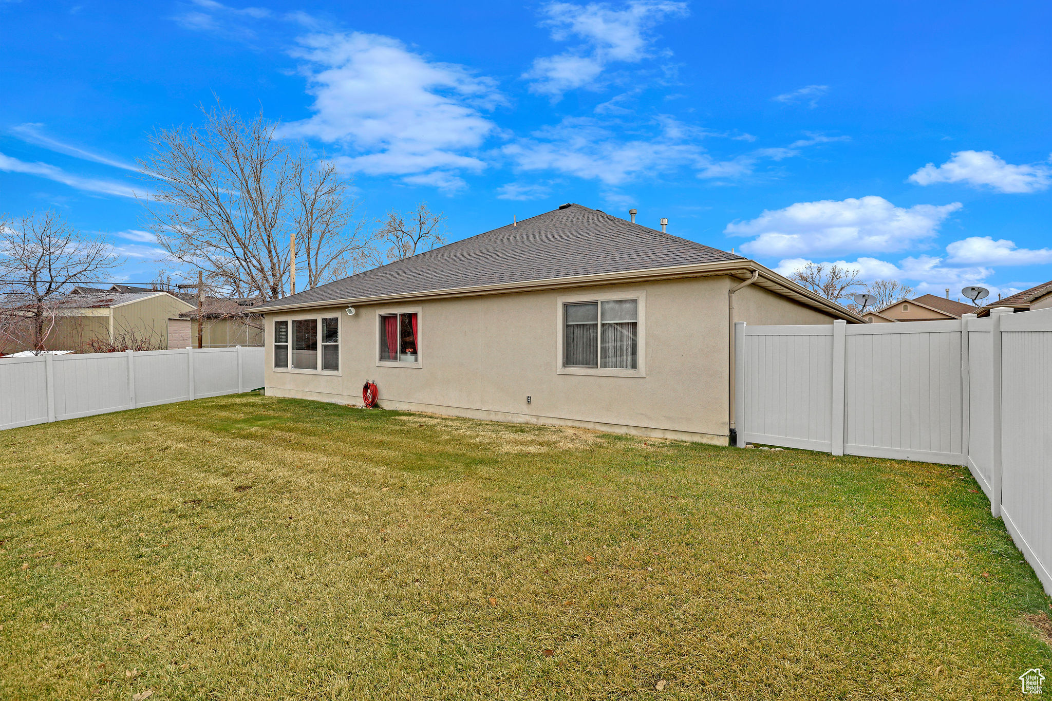 Back of property featuring a yard