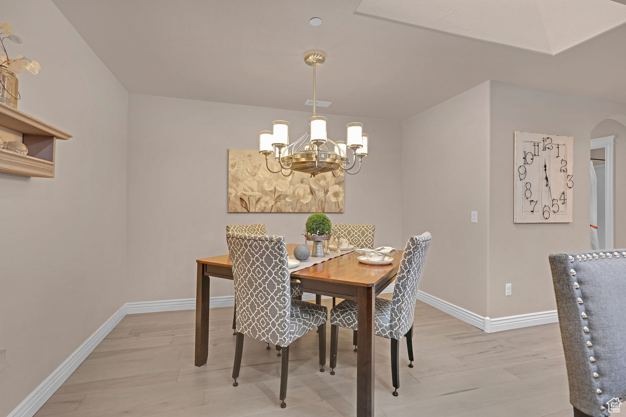 Dining space featuring light wood-type flooring and an inviting chandelier