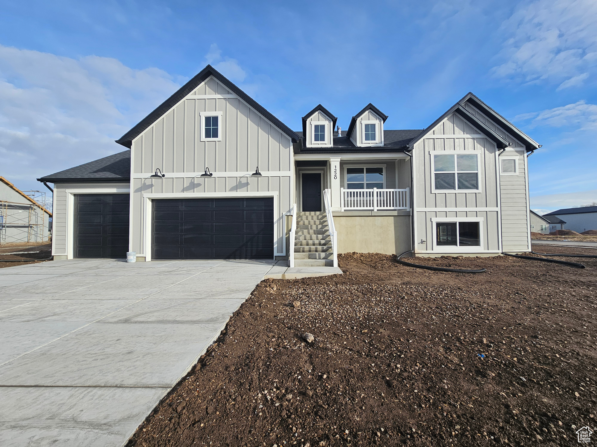 View of front of house featuring covered porch and a garage