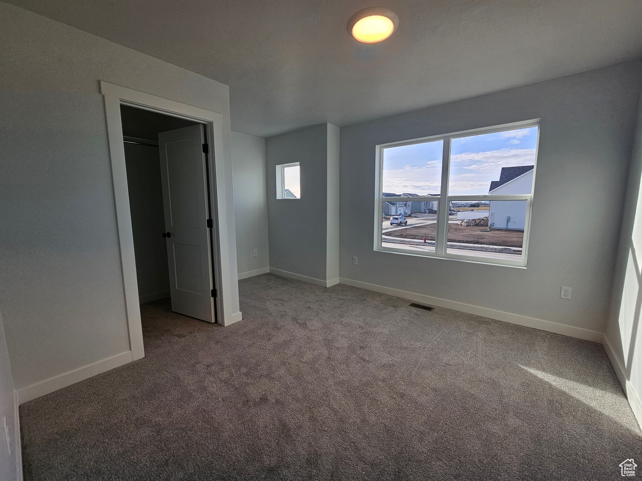 Unfurnished bedroom with a closet and carpet floors