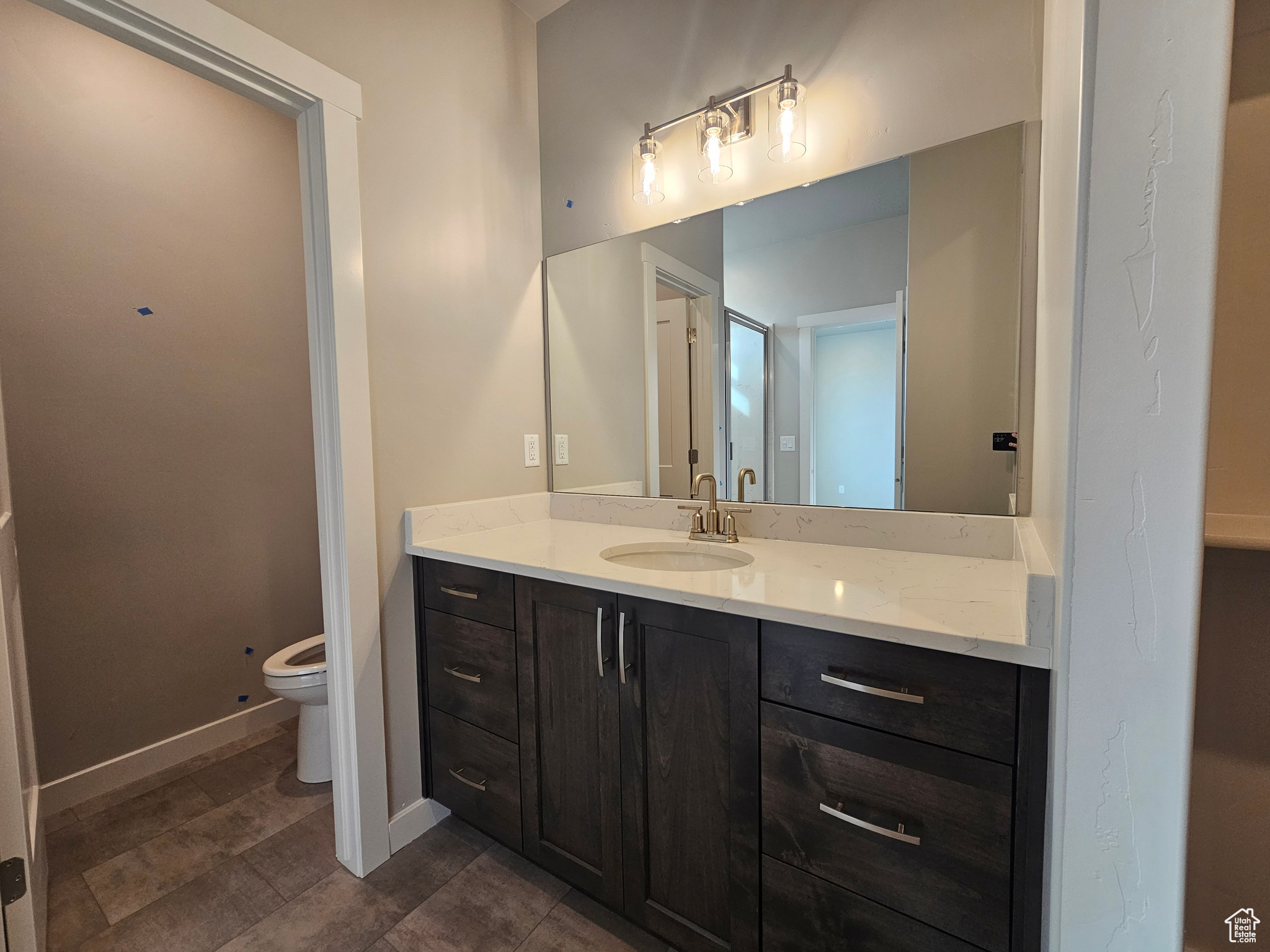 Bathroom featuring vanity and toilet