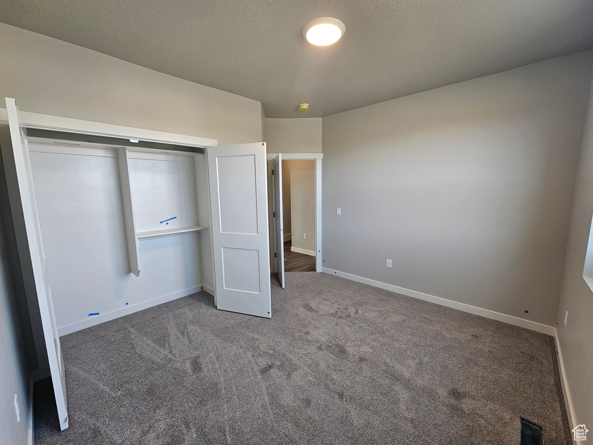 Unfurnished bedroom with carpet flooring and a closet