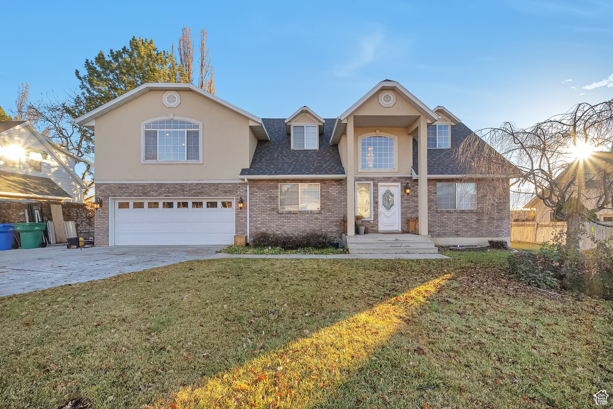 View of property featuring a front yard and a garage