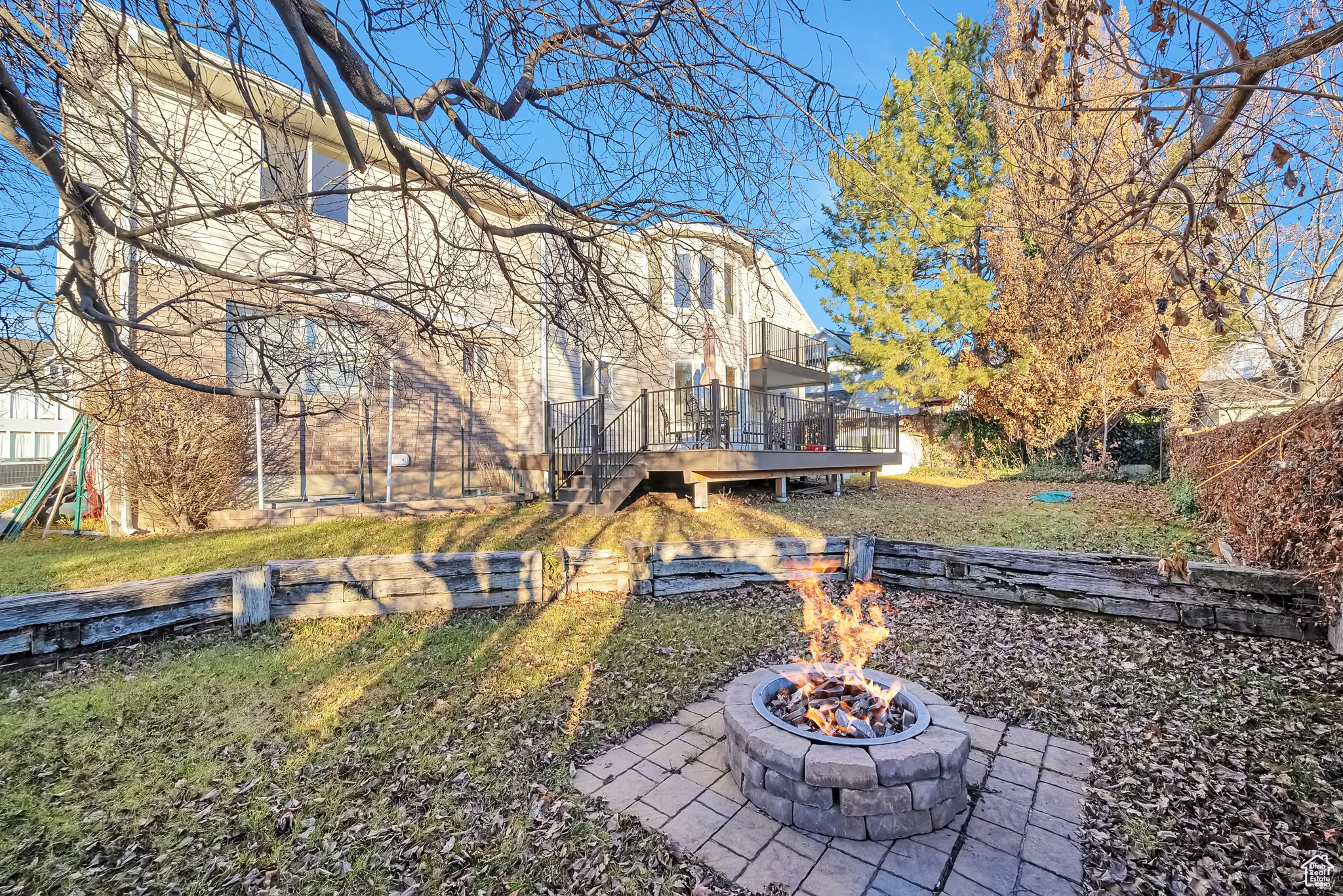 View of yard with a wooden deck and an outdoor fire pit