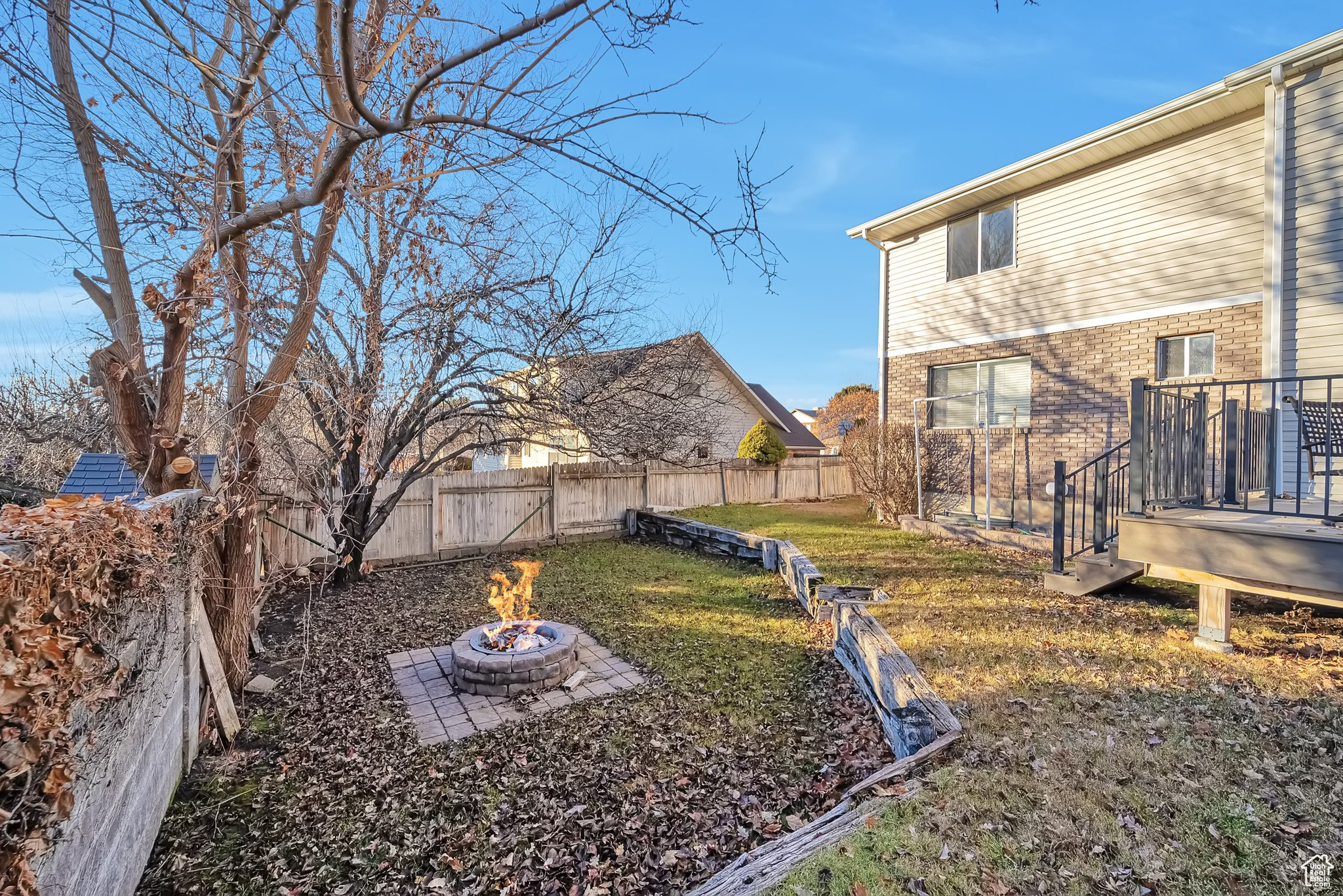 View of yard featuring a fire pit and a wooden deck