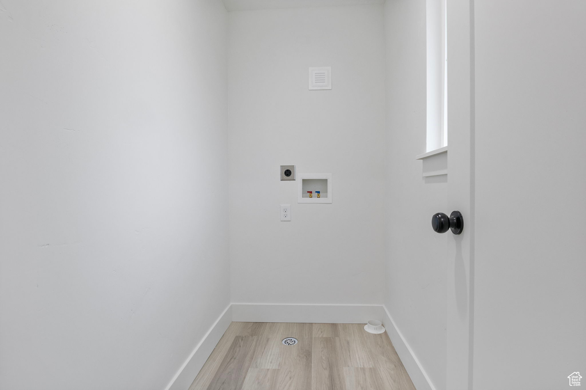 Laundry room off primary suite with hookup for an electric dryer, washer hookup, and light lip flooring