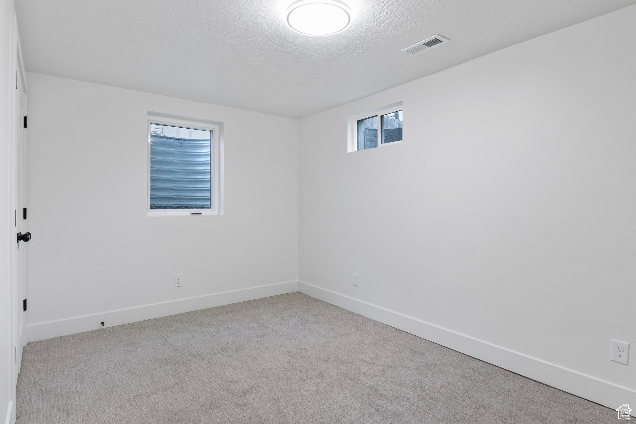 Bedroom 4 with carpeted floors, closet and a textured ceiling