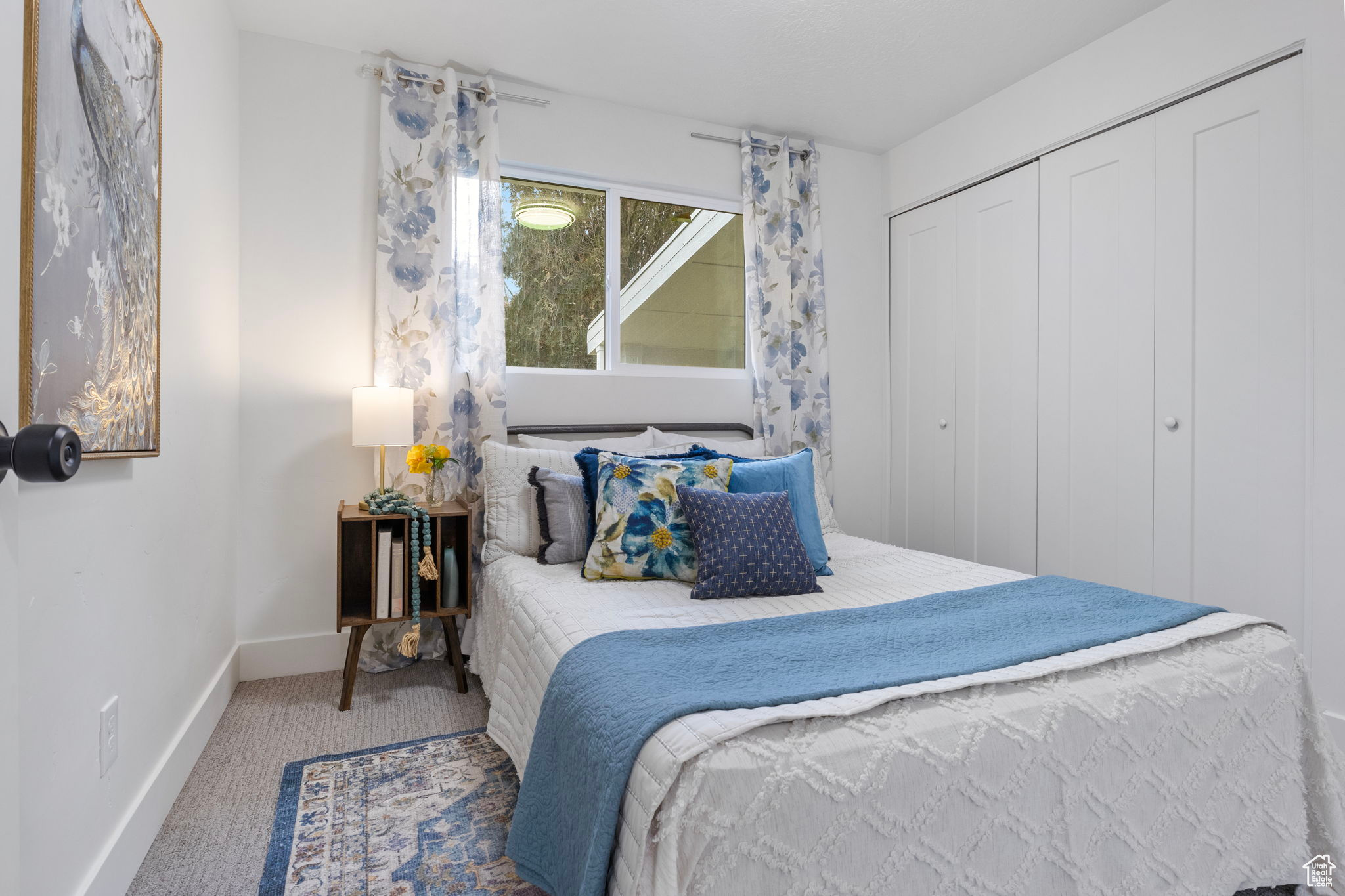 Carpeted bedroom with a closet