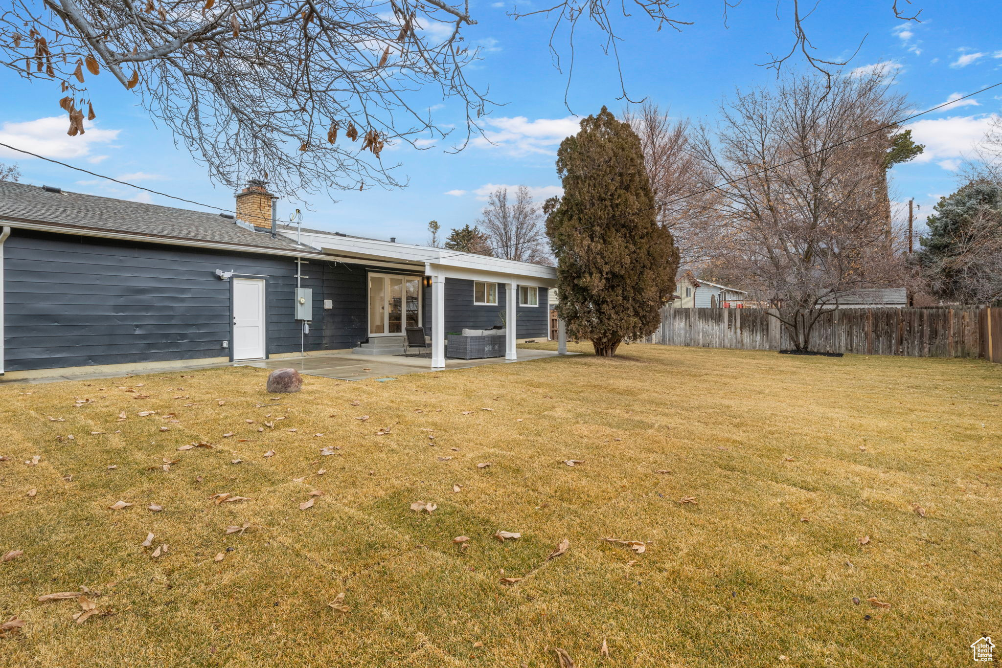 Rear view of house featuring a patio area and a lawn