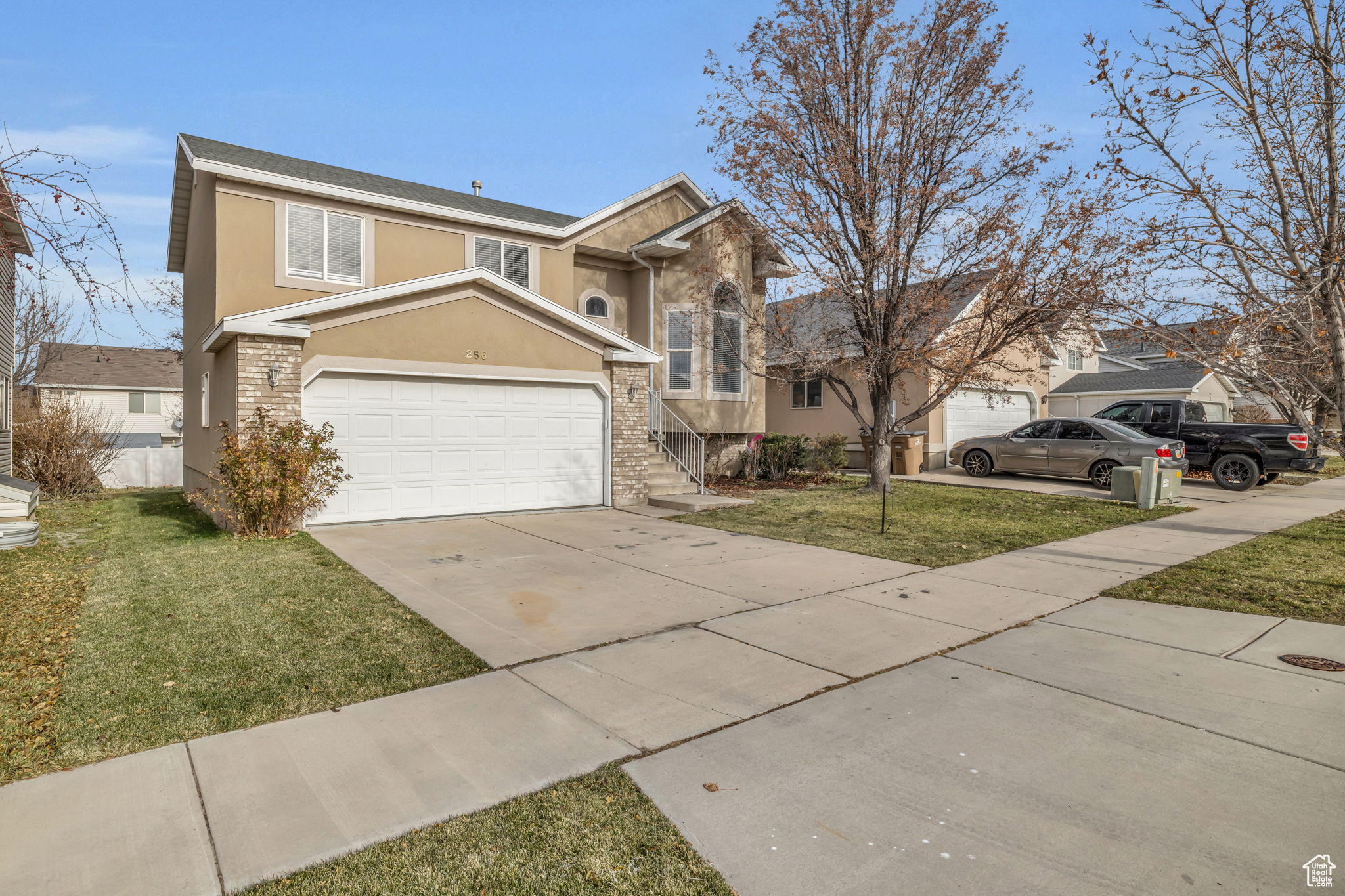 View of front of home featuring a garage and a front lawn