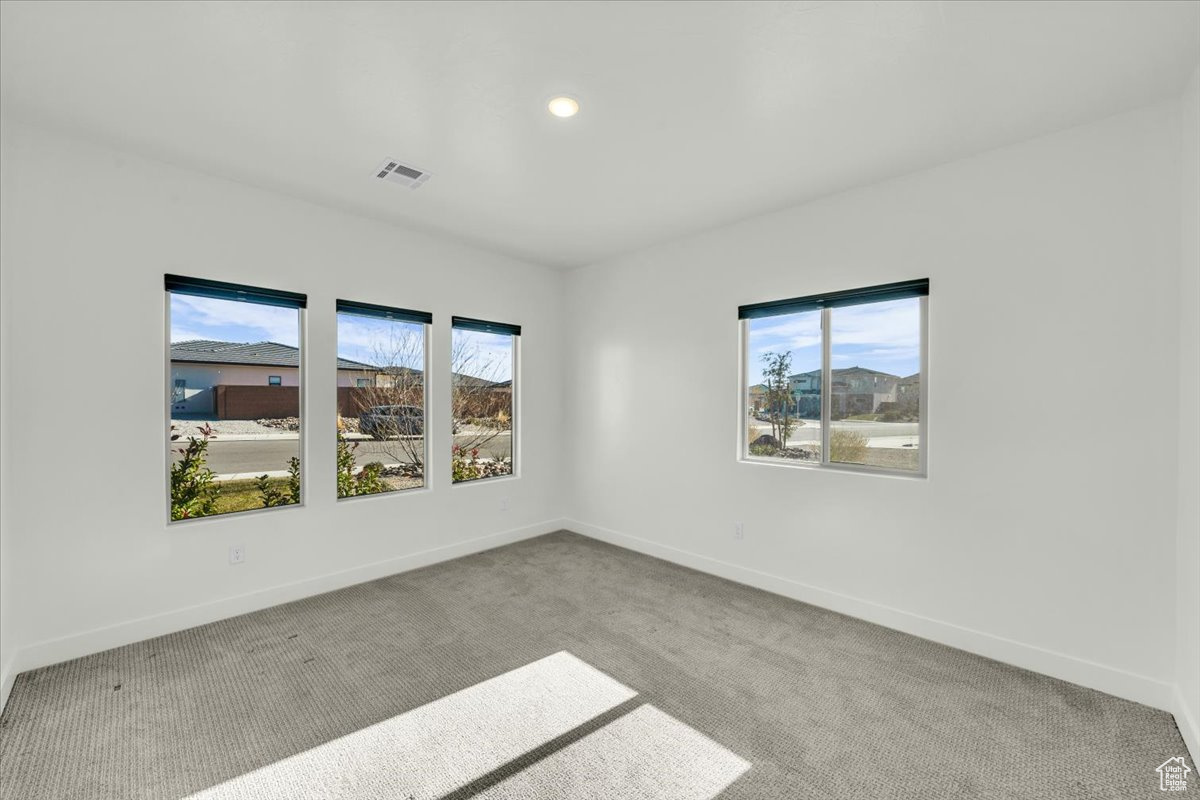 Carpeted spare room with plenty of natural light