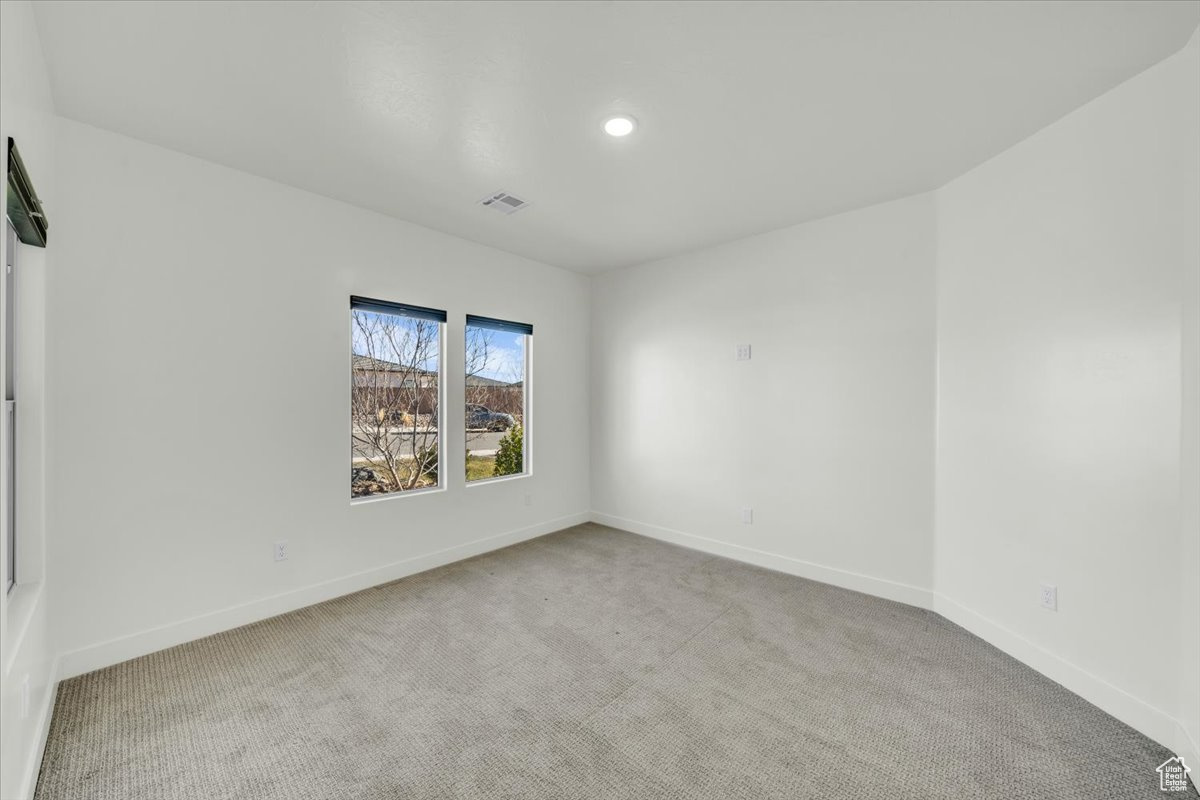 Unfurnished room featuring light colored carpet