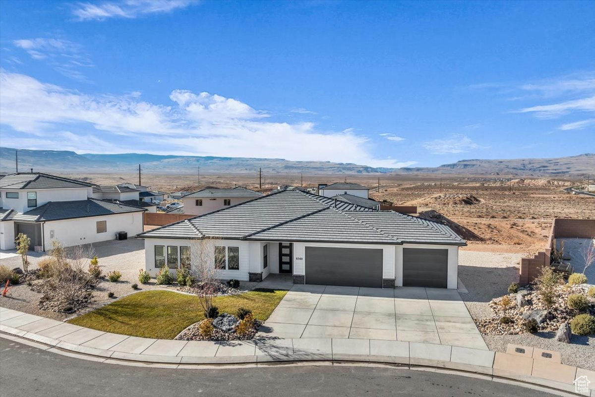 Ranch-style house featuring a mountain view and a garage