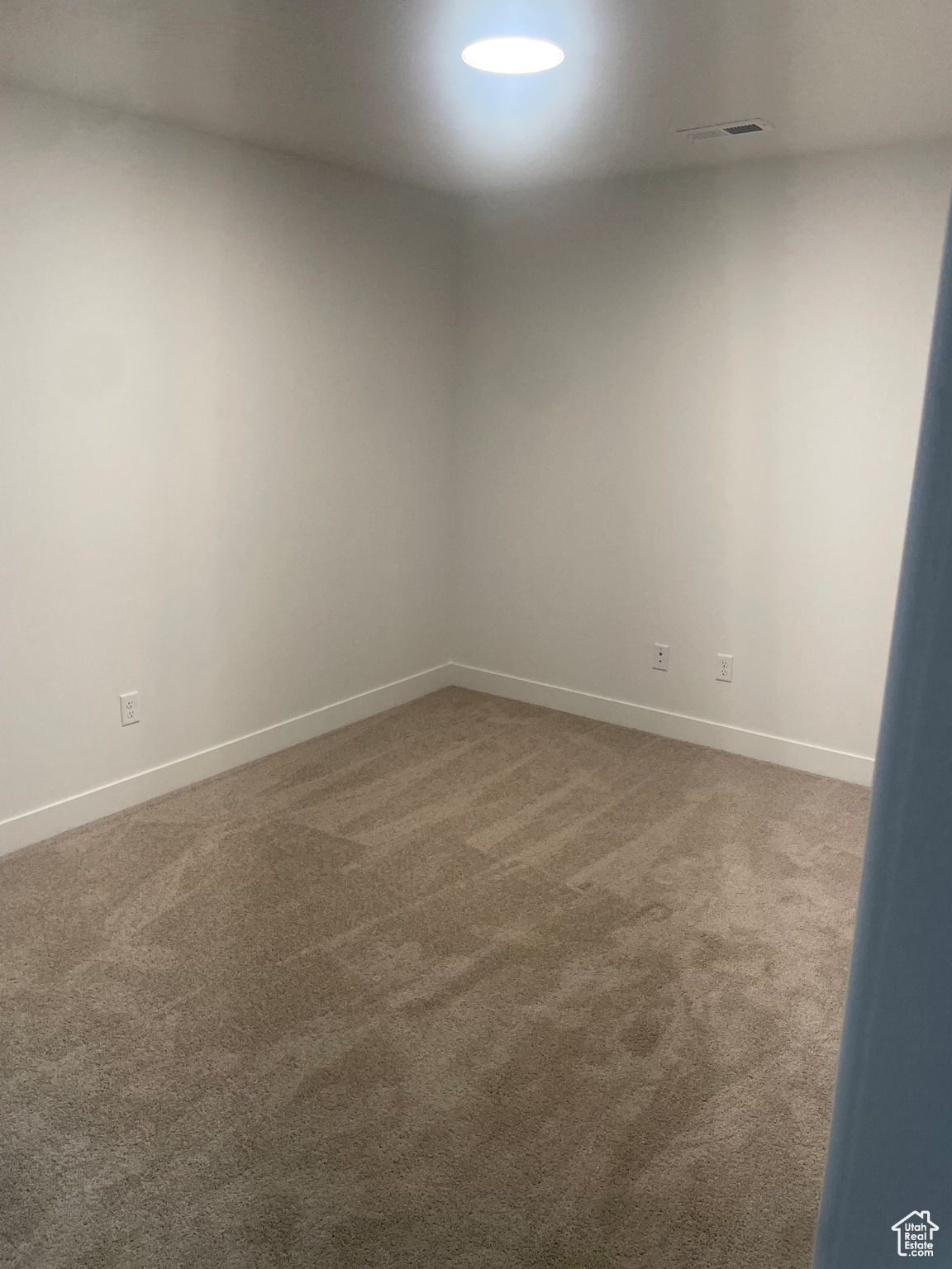 Spare room featuring carpet