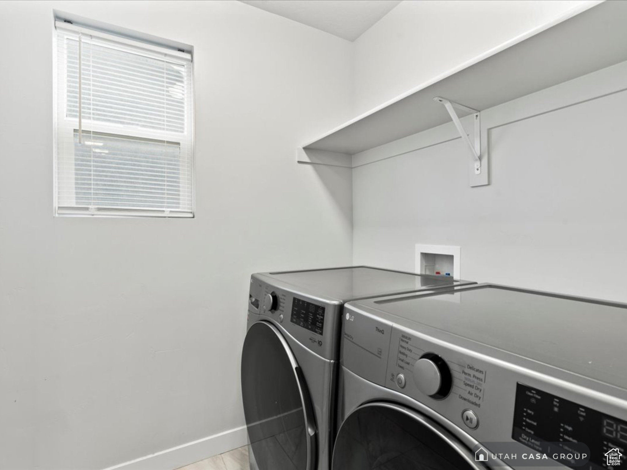 Laundry room with light tile patterned floors and independent washer and dryer