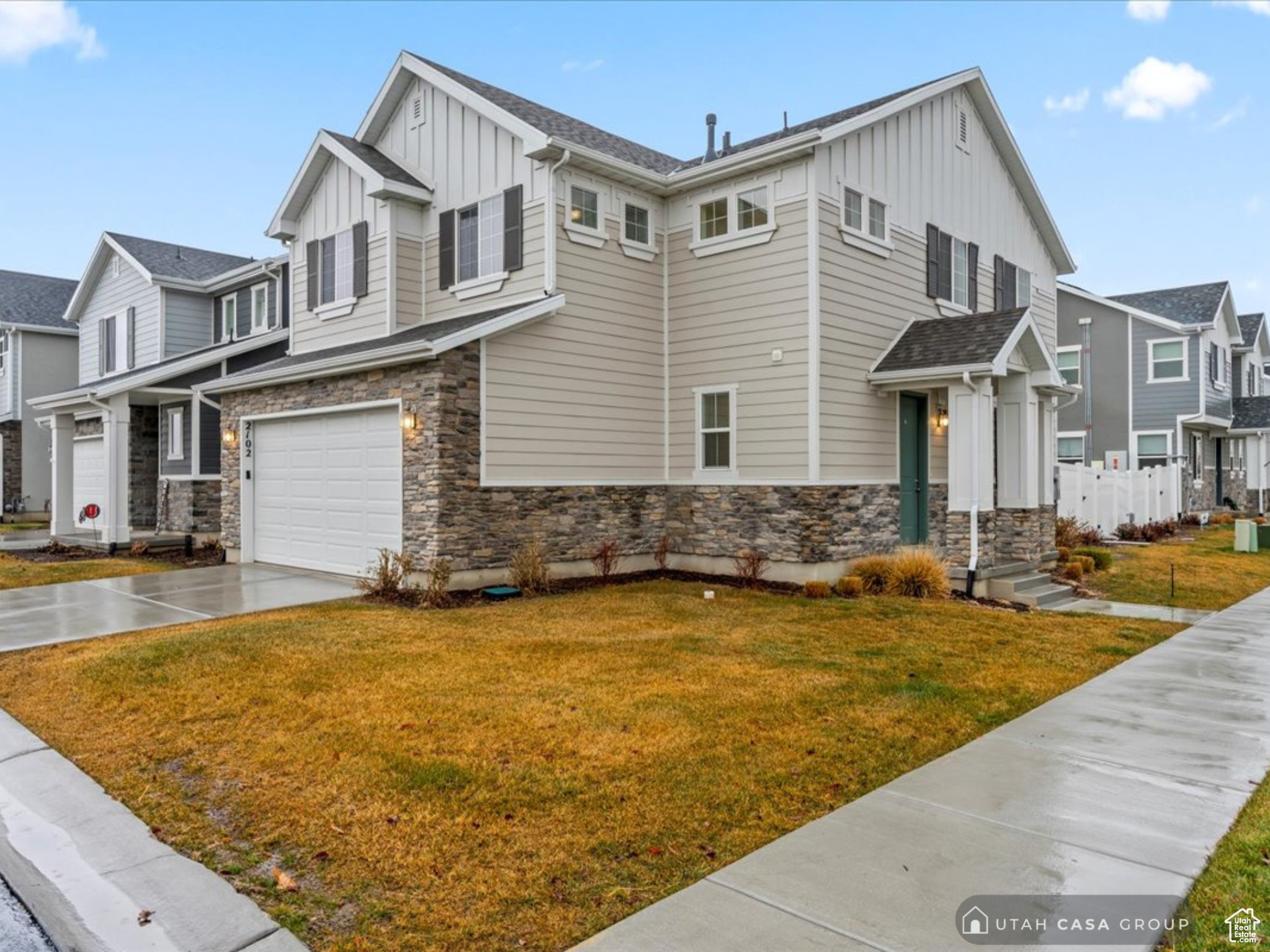 View of front of house featuring a garage and a front lawn